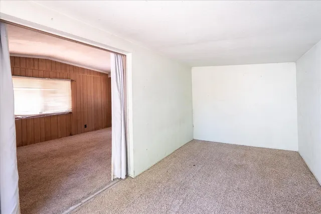 a view of a big room with windows and entryway