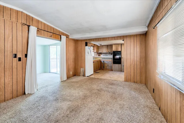 a kitchen with a sink refrigerator and window