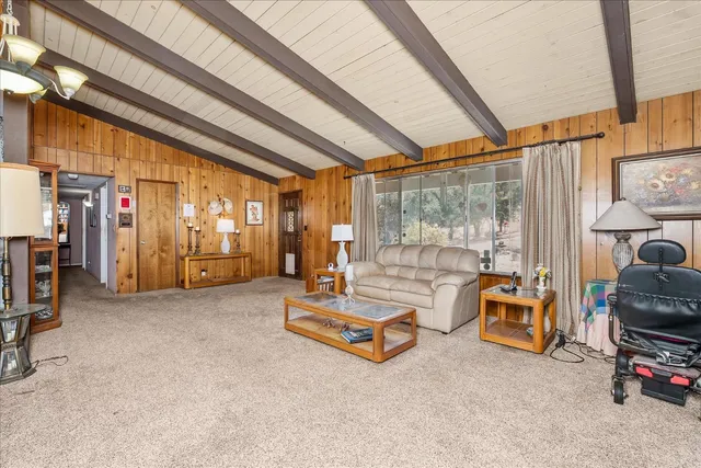 a living room with furniture gym equipment and large windows