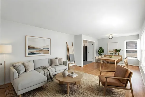 a living room with furniture and wooden floor
