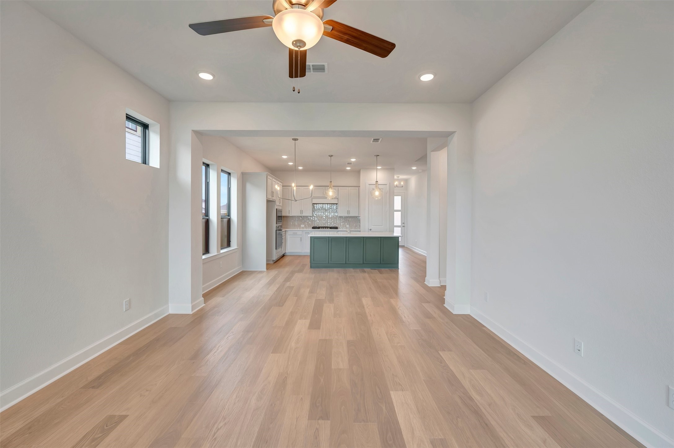 2718 Cottage Place Rosharon, TX 77583 - Photo 26 of 50 a view of a hallway with wooden floor and a kitchen