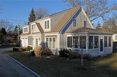 127 West Bay Road, Unit A Osterville, MA 02655 - Photo 2 of 11 a front view of a house with a yard