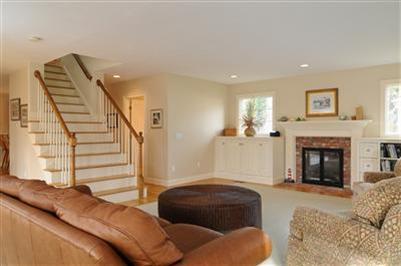 127 West Bay Road, Unit A Osterville, MA 02655 - Photo 5 of 11 a living room with furniture and a fireplace