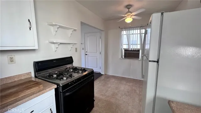 a kitchen with a stove and a refrigerator