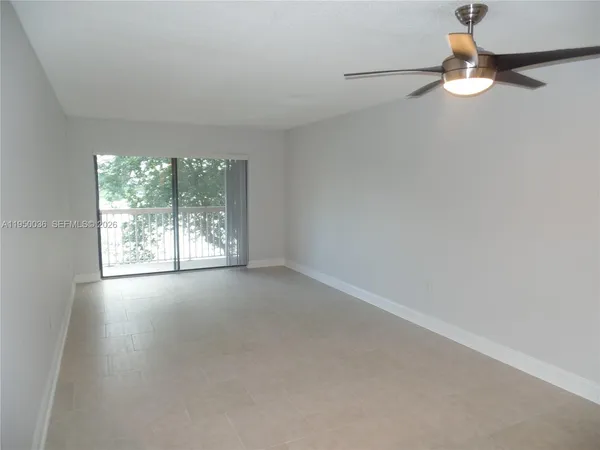 an empty room with windows and entrance