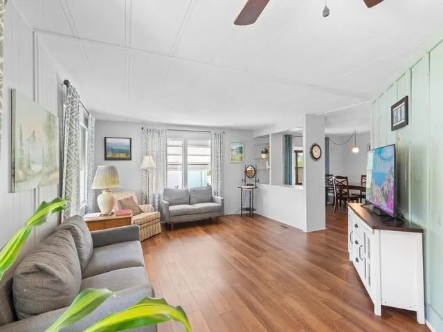 a living room with furniture flat screen tv and a couch