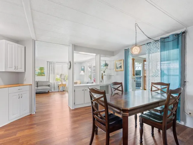 a dining room with furniture and wooden floor