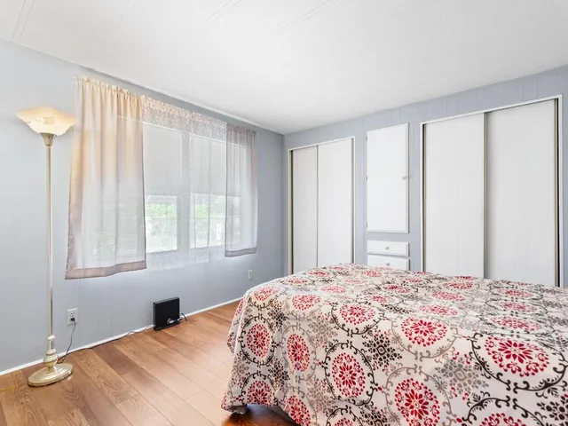 a bedroom with a large bed and a window