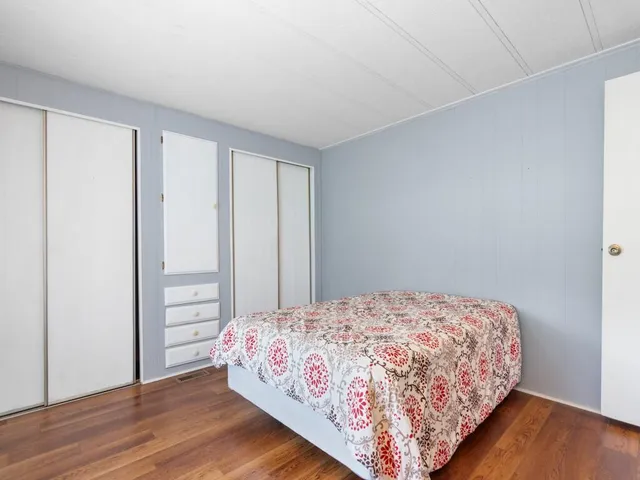 a bed sitting in a bedroom next to a window