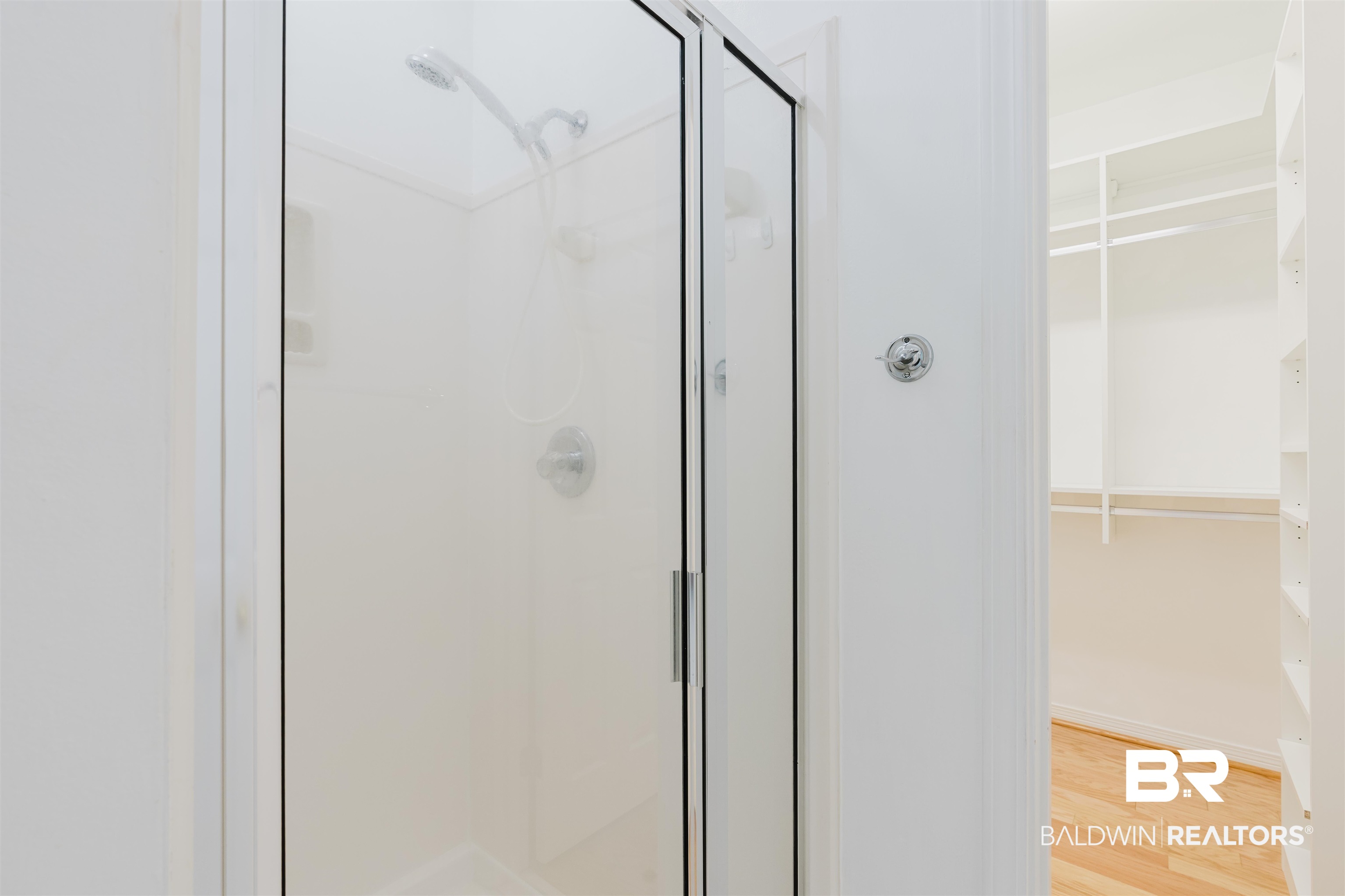19711 Hunters Loop Fairhope, AL 36532 - Photo 24 of 49 Full bath featuring a stall shower, a walk in closet, and wood finished floors