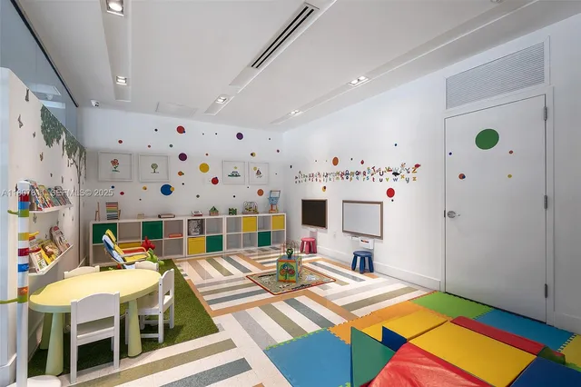 a living room with patio furniture and a chandelier