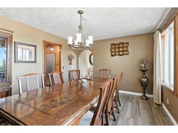 a view of a dining room with furniture wooden floor and chandelier