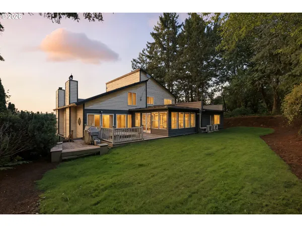 a view of a house with a backyard and a patio