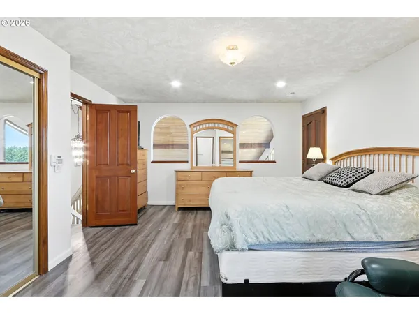 a bedroom with a bed and a dresser