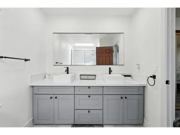 a bathroom with a double vanity sink and mirror