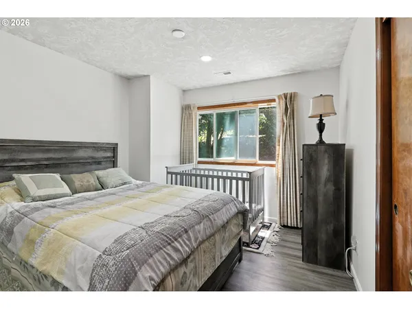 a bedroom with a bed and a large window