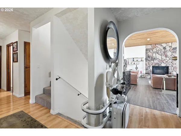 a living room with furniture and a large mirror