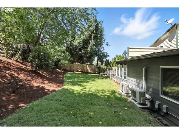a backyard of a house with table and chairs