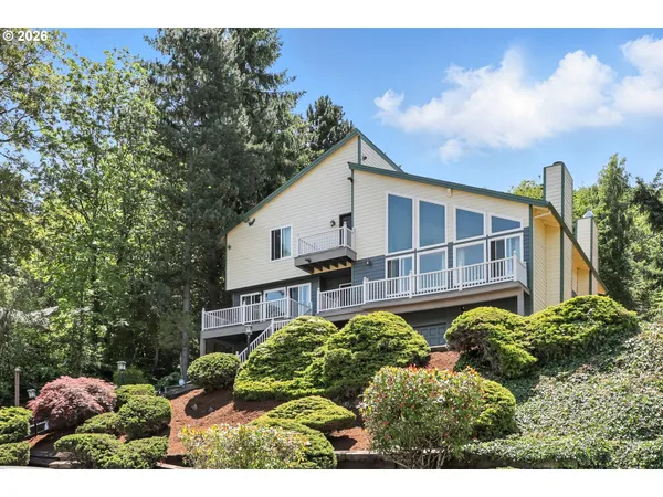 a view of a house with a yard and potted plants