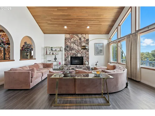 a living room with fireplace furniture and a large window