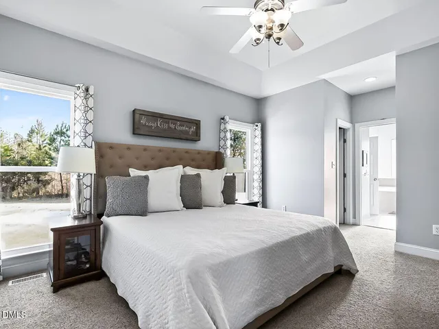 a bedroom with a large bed and a chandelier