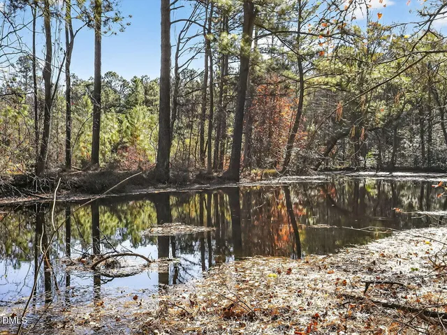 a view of a balcony with chairs and wooden fence