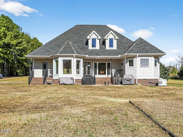 a front view of a house with a garden and porch