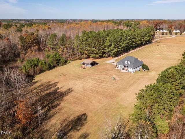 an aerial view of residential houses with city view