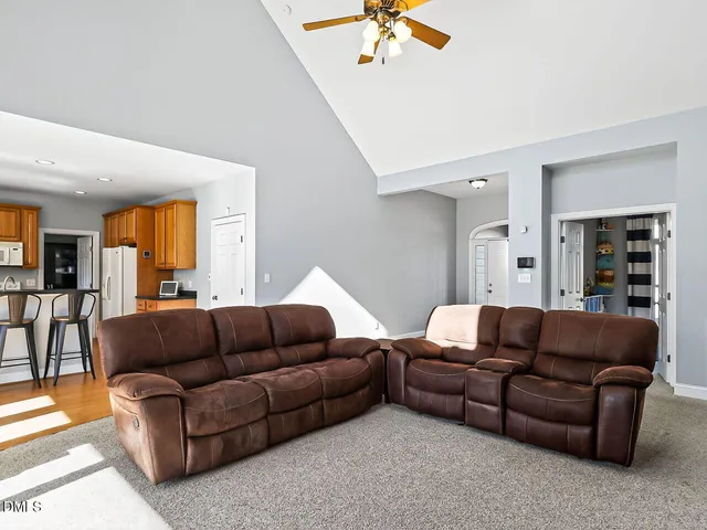 a living room with furniture and a potted plant