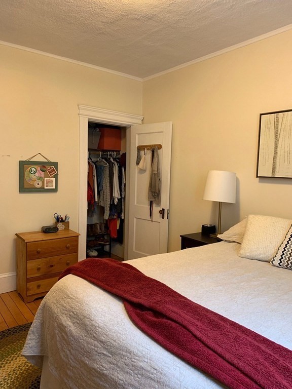 16 Royce Road, Unit 5 Boston, MA 02134 - Photo 6 of 10 a bedroom with a bed and a dresser