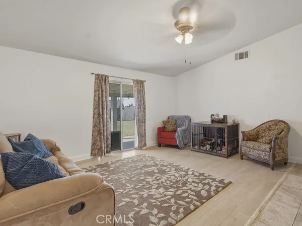 a bedroom with a bed and a flat tv screen on the dresser