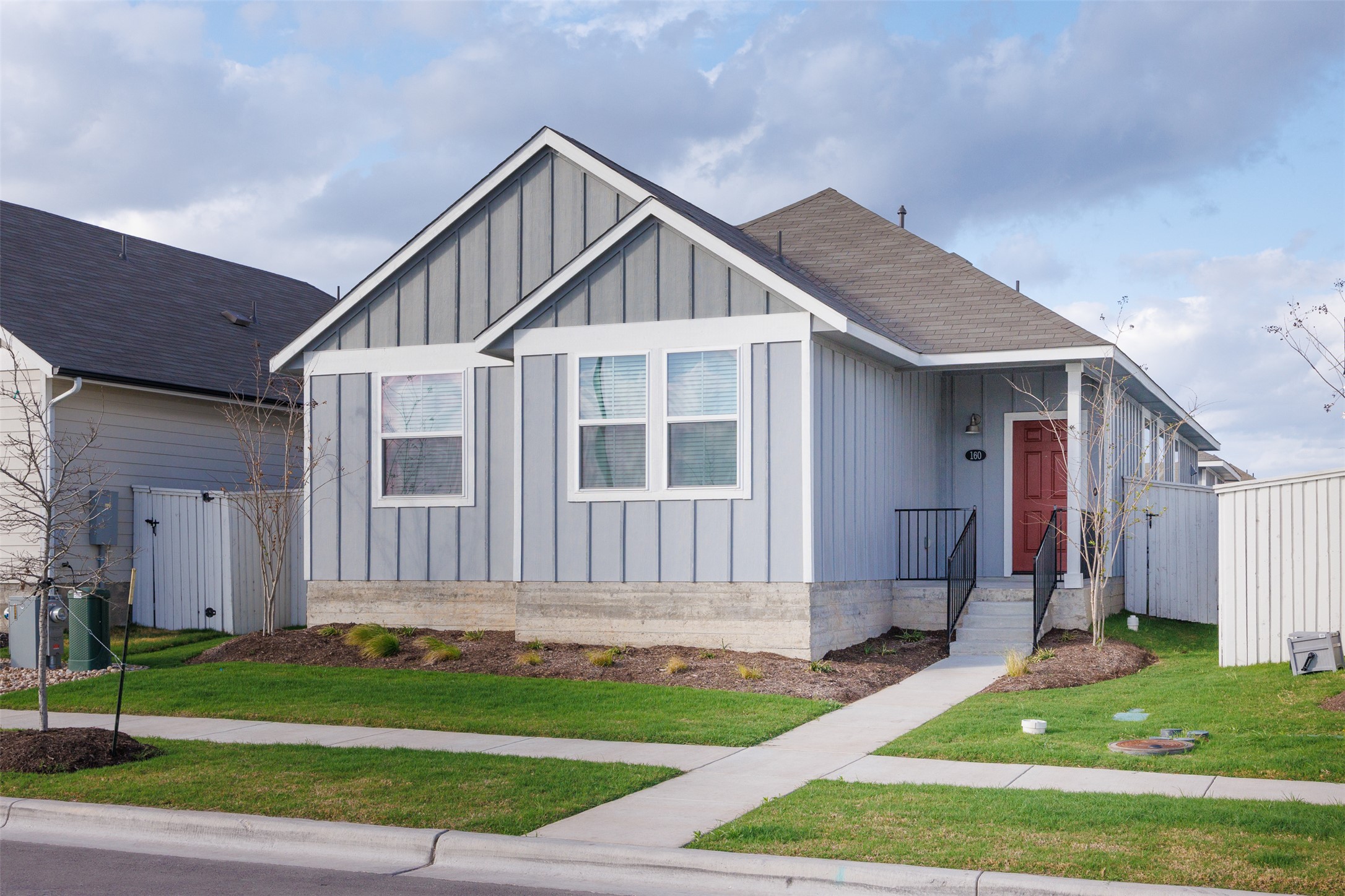 View of front of house featuring board and batten siding and a shingled roof