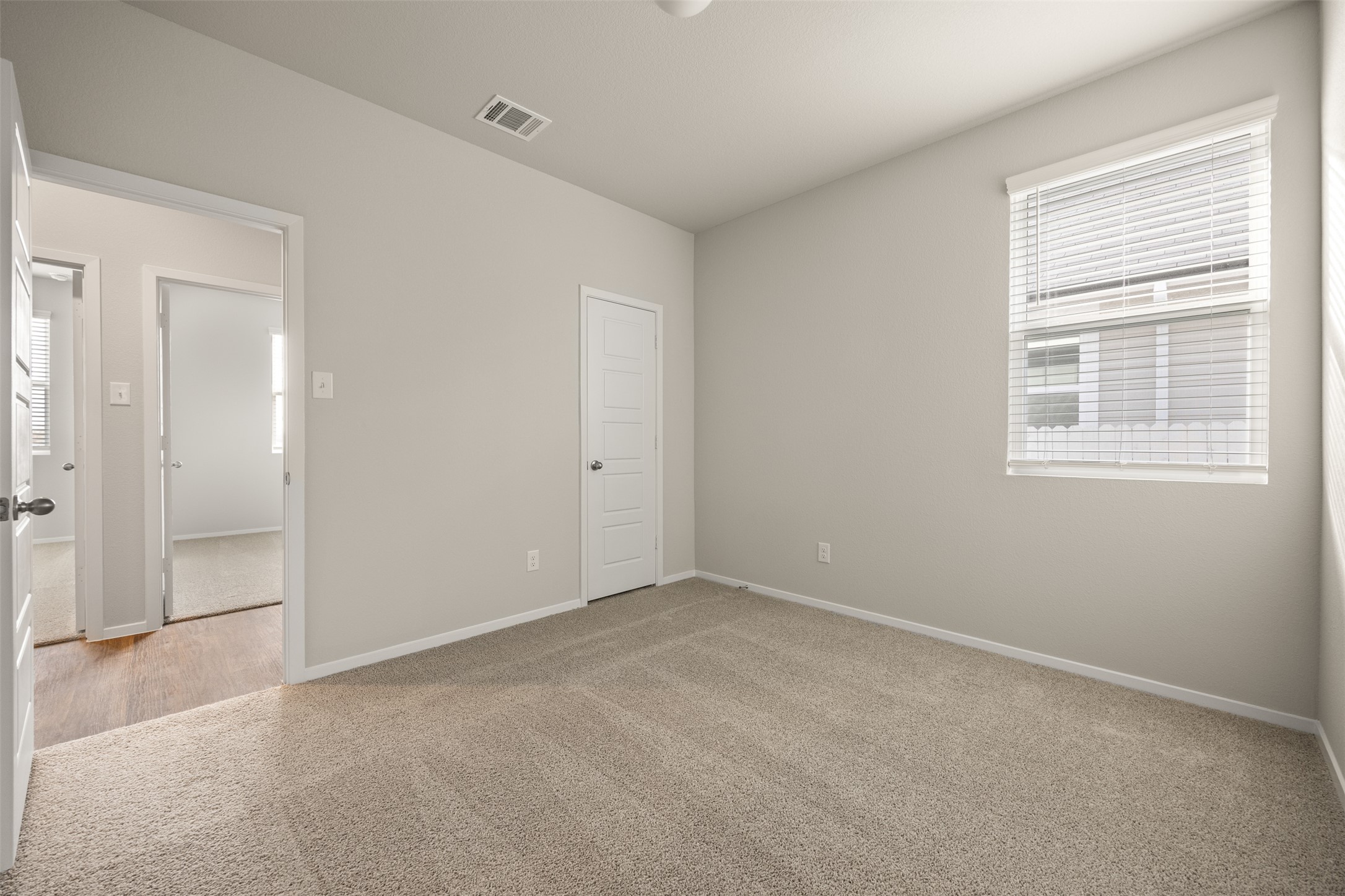 160 Backwater Road Kyle, TX 78640 - Photo 11 of 15 Unfurnished bedroom with light colored carpet and baseboards