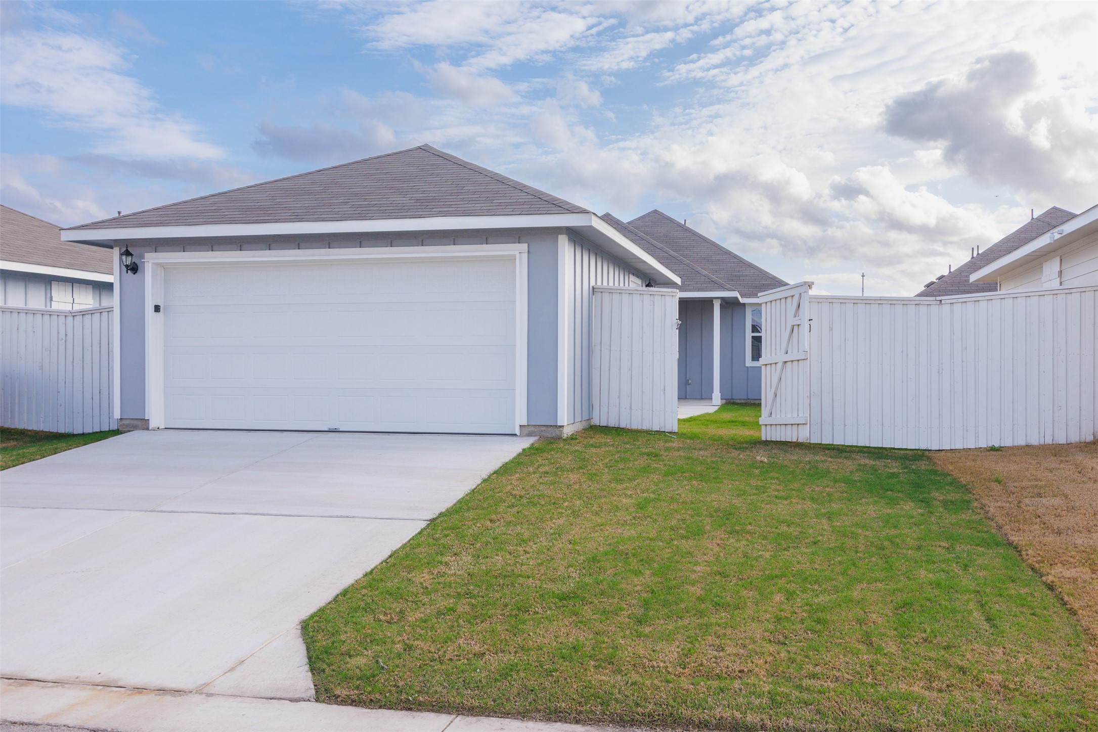 160 Backwater Road Kyle, TX 78640 - Photo 2 of 15 Ranch-style house featuring roof with shingles, board and batten siding, driveway, and a garage