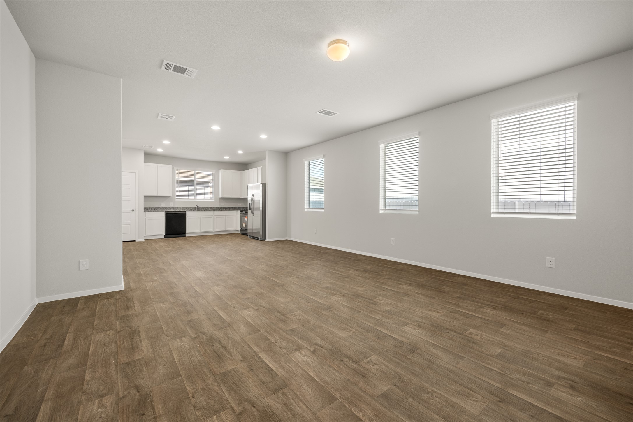 160 Backwater Road Kyle, TX 78640 - Photo 4 of 15 Unfurnished living room with recessed lighting and dark wood-type flooring