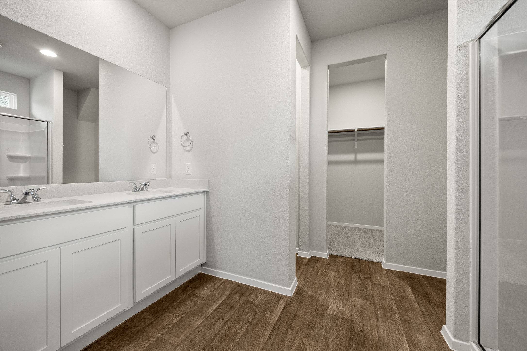 160 Backwater Road Kyle, TX 78640 - Photo 9 of 15 Full bath featuring a shower stall, double vanity, dark wood-style floors, and a walk in closet