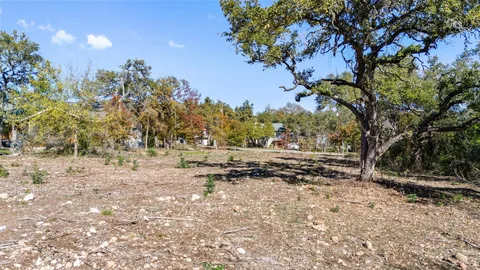 a view of dirt yard with a tree