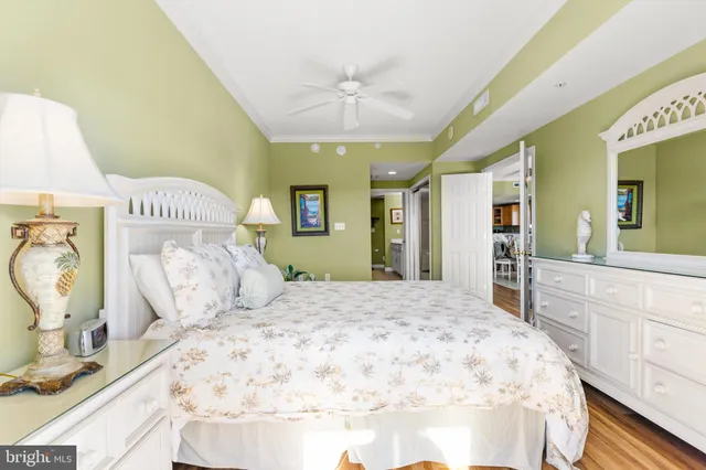 a spacious bedroom with a bed and a dresser