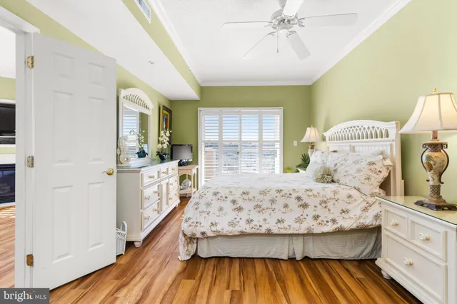 a bedroom with a bed and a view of living room