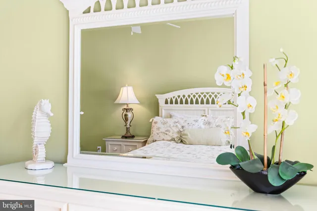 a bedroom with a bed and a potted plant