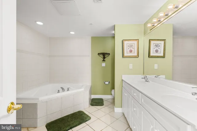 a bathroom with a tub sink and mirror