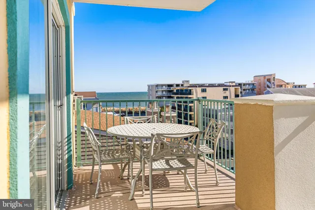a view of a balcony with a table and chairs