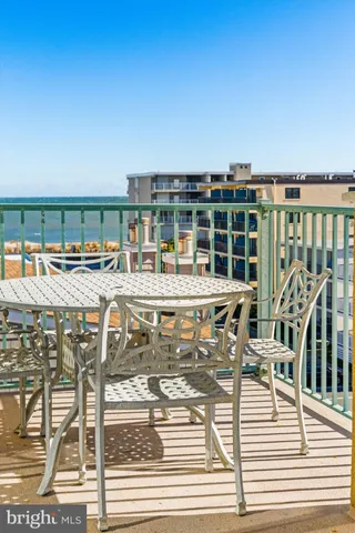 a view of a swimming pool with outdoor seating