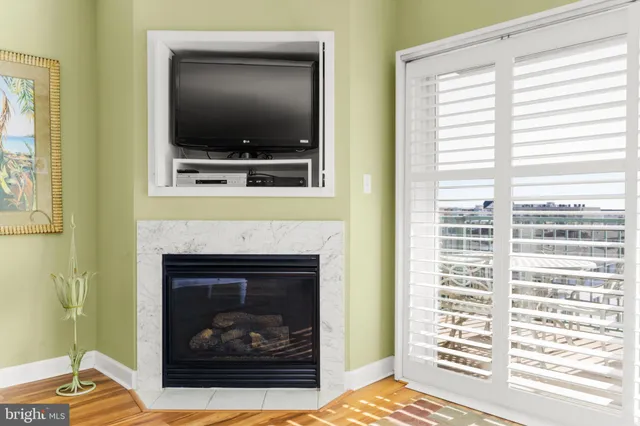 a living room with a fireplace and a flat screen tv