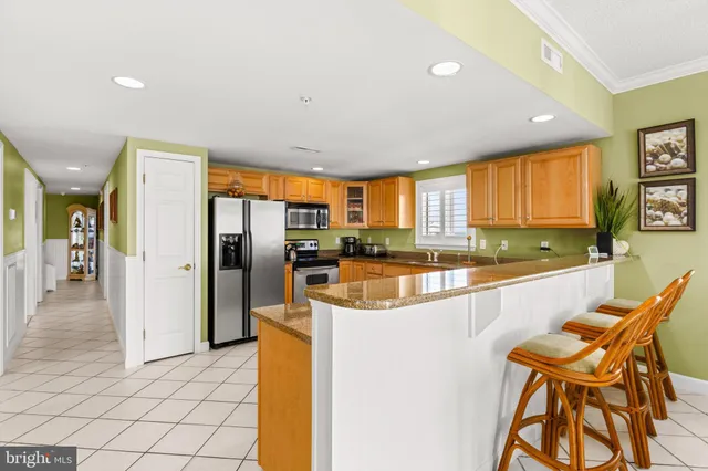 a kitchen with stainless steel appliances granite countertop a refrigerator and a stove top oven