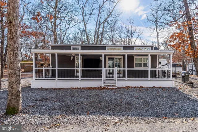 a view of a house with a large window and large trees