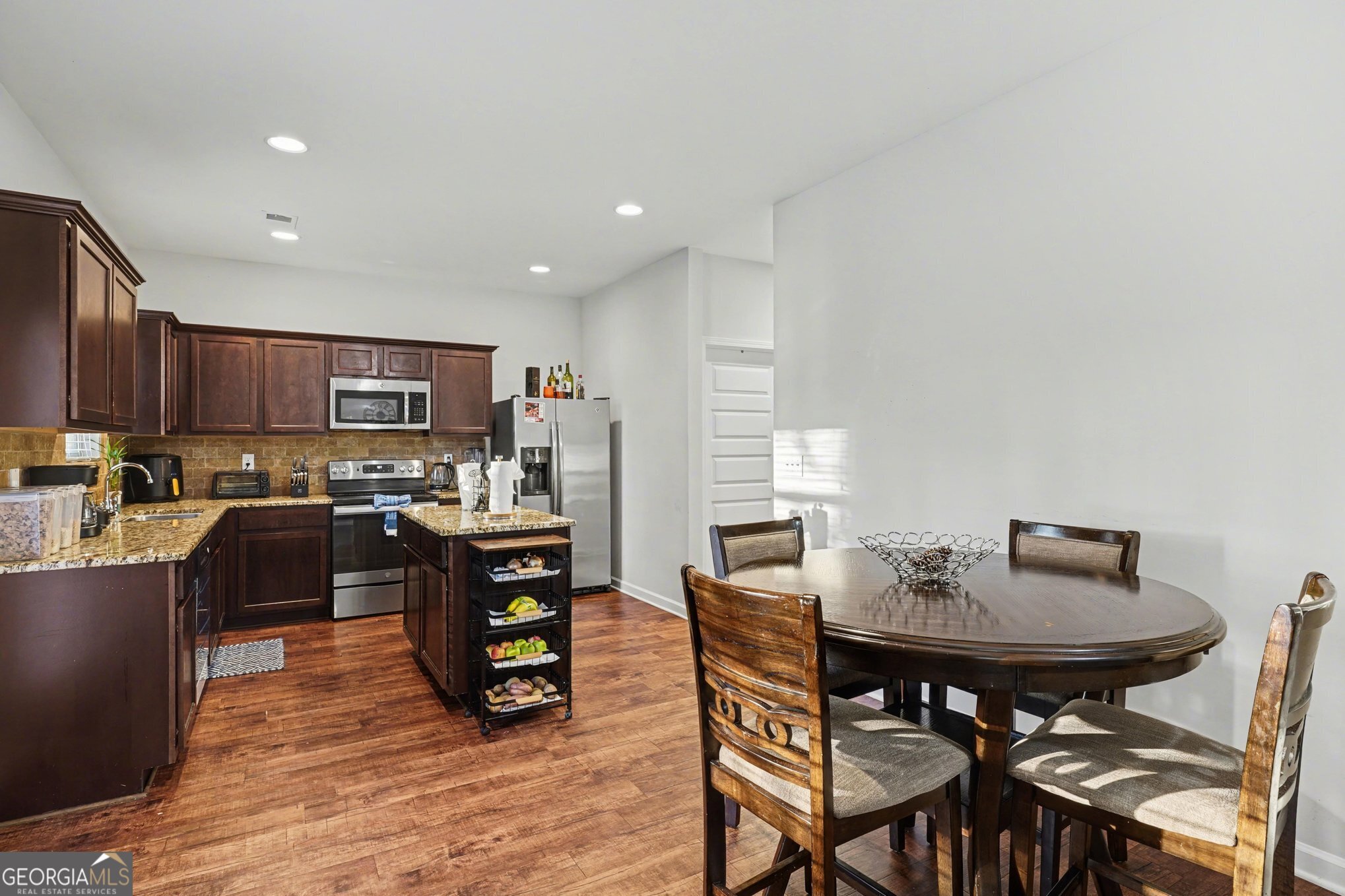 1241 England Terrace Hampton, GA 30228 - Photo 6 of 20 a view of a dining room with furniture and wooden floor