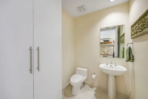a bathroom with a sink toilet and a mirror