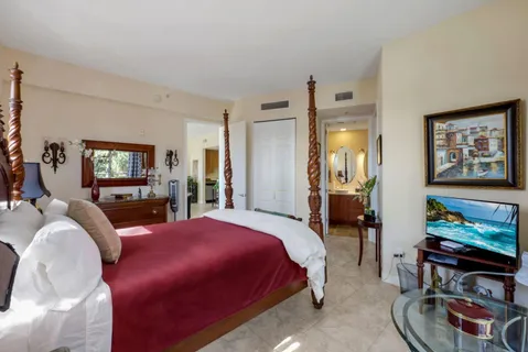 a bedroom with a bed a couch and dresser