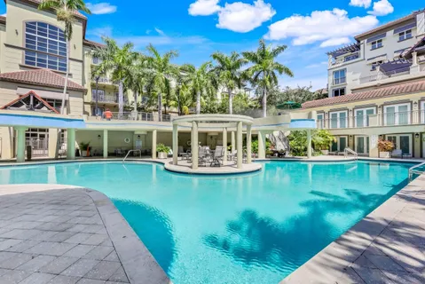 a view of a house with pool yard and sitting area